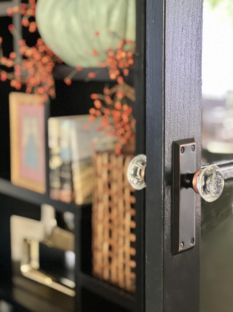 French doors painted black with glass door knob.