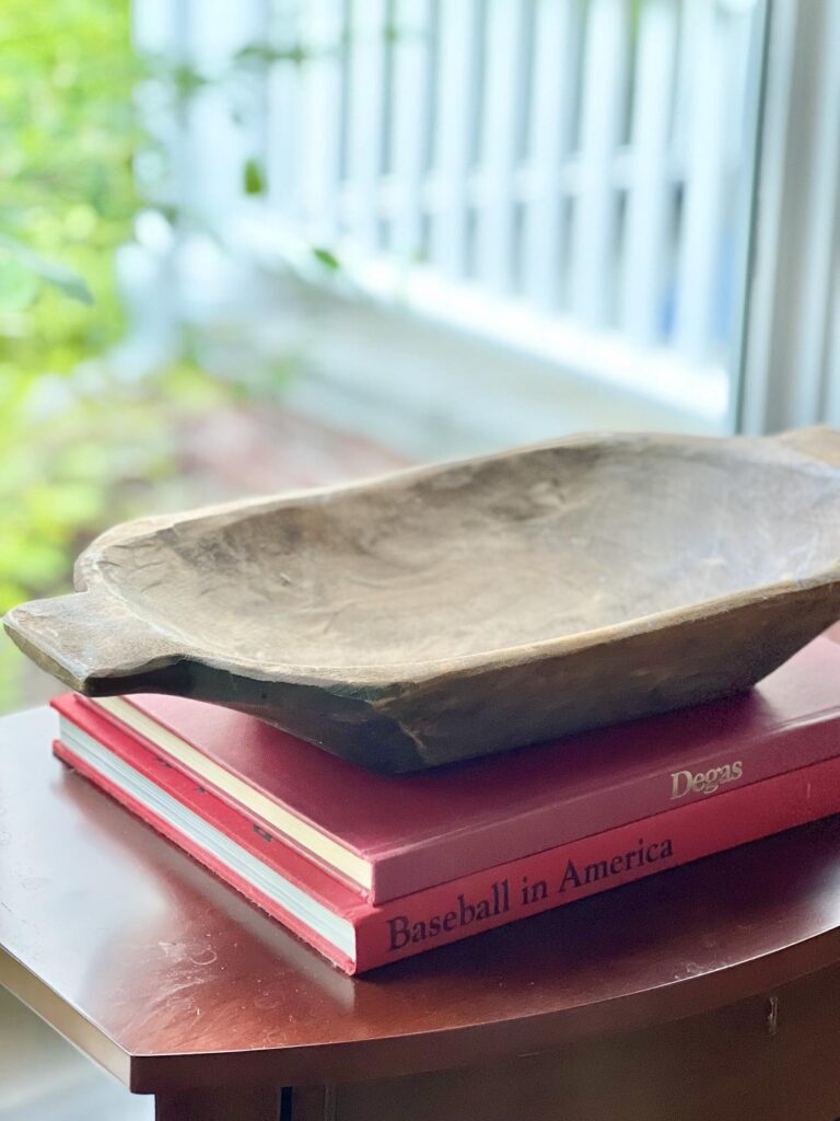 Decorating with dough bowls by placing the bowl on top of a stack of red books.