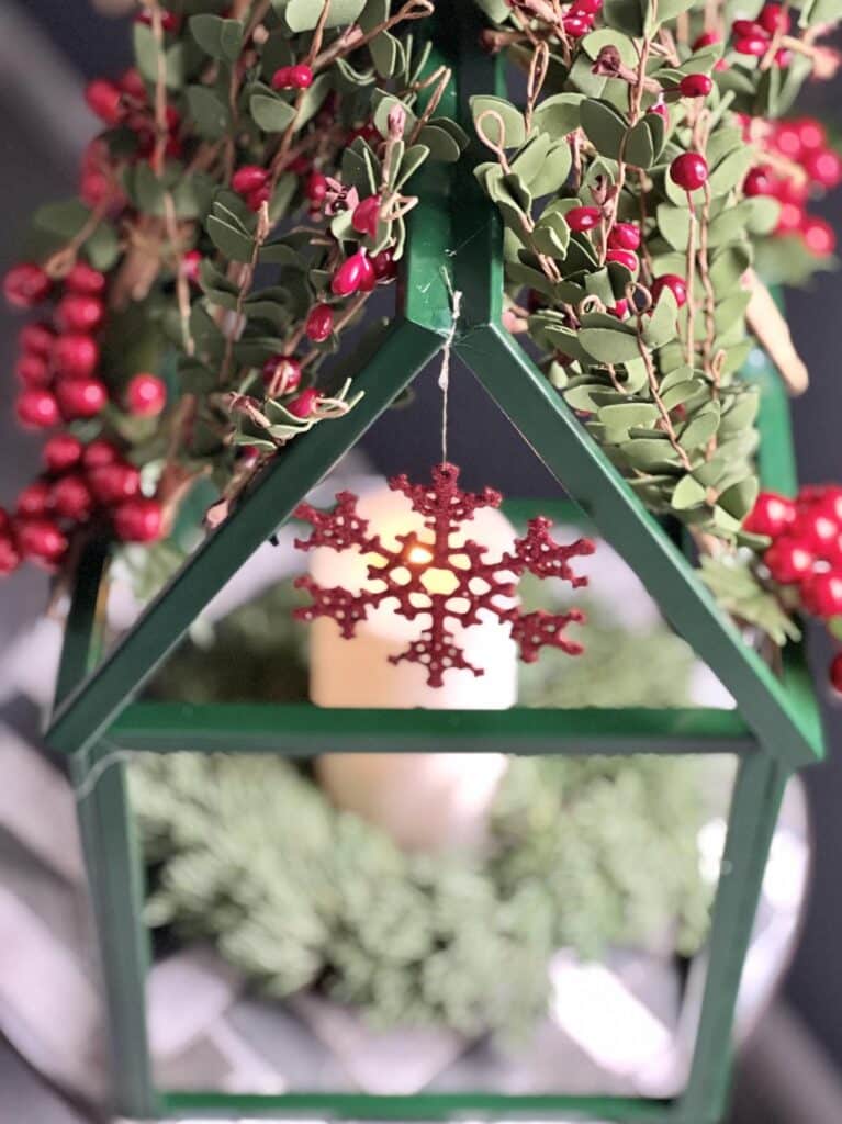 A red snowflake ornament hanging from the greenhouse.