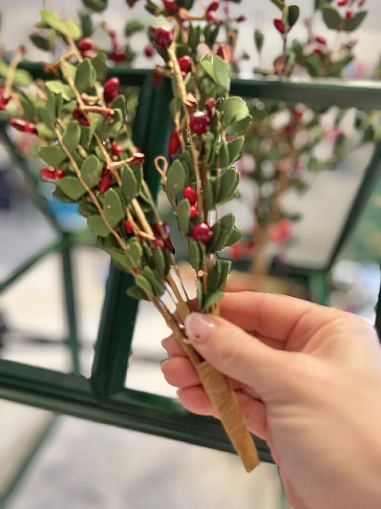 Green stems with holly berries.