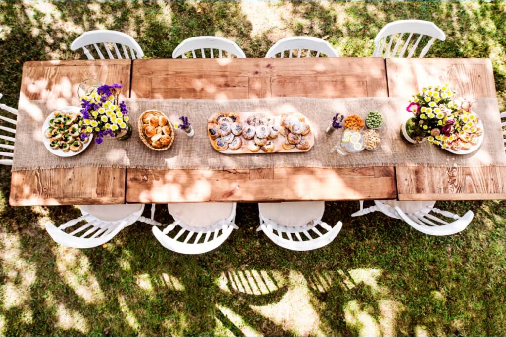 A burlap table runner on a garden table.