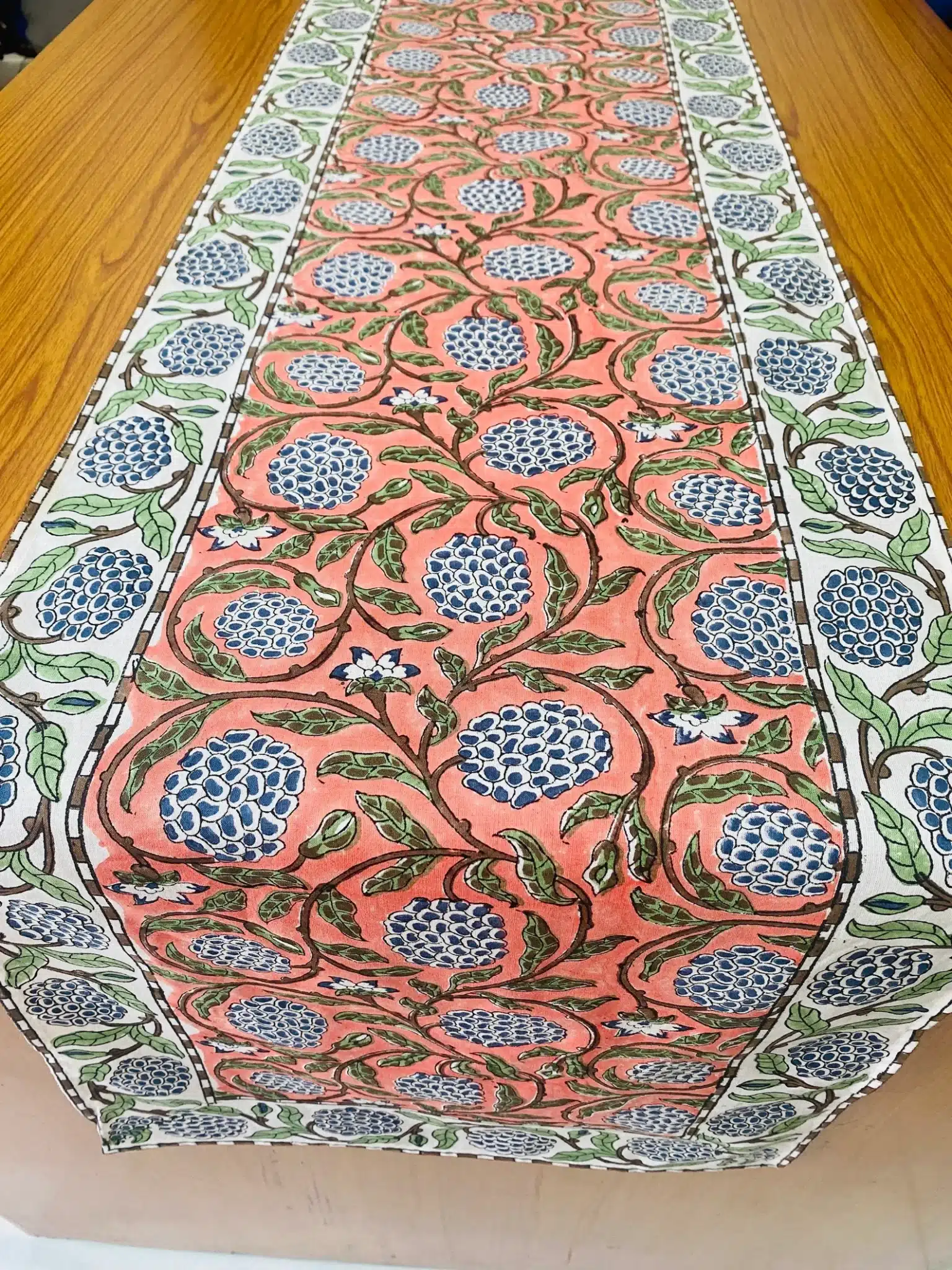 A hand block print table runner used for decorating a round table.