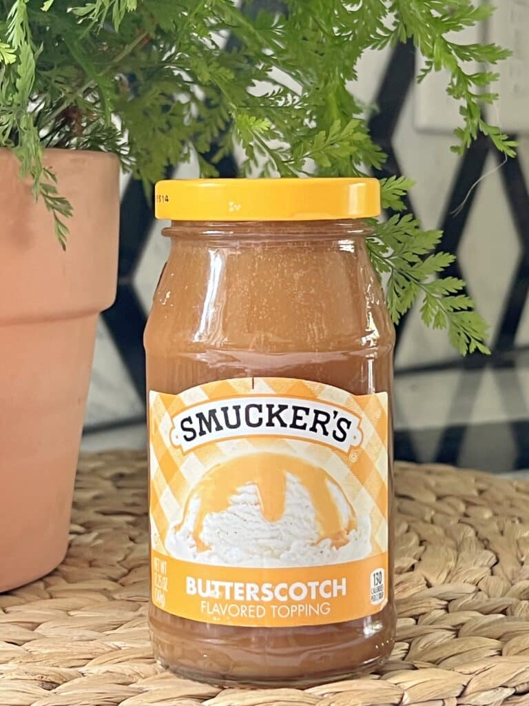 A jar of butterscotch topping.