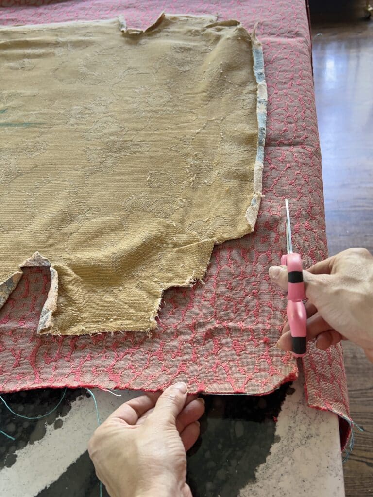 upholstery diy chair seat: Cutting the fabric using the old fabric as the pattern.