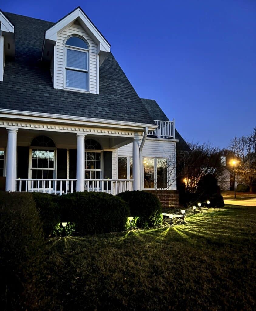 solar pathway lights illuminate a fall front porch in a budget friendly way to highlight decorating.