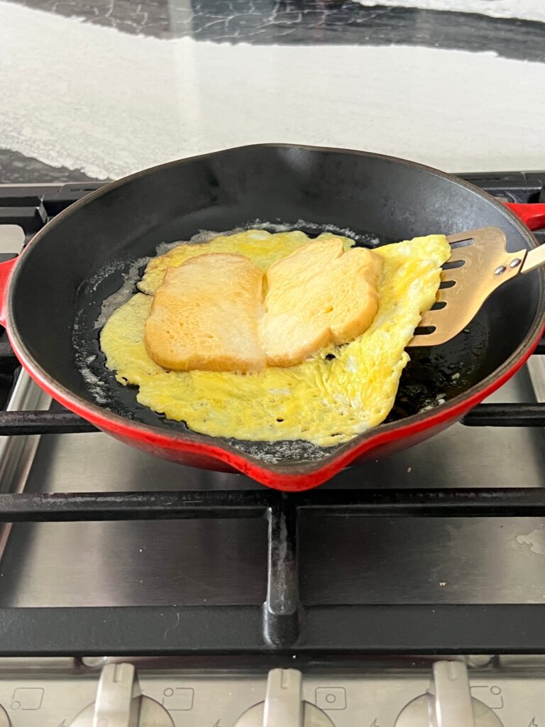 Flipping eggs and bread slices.