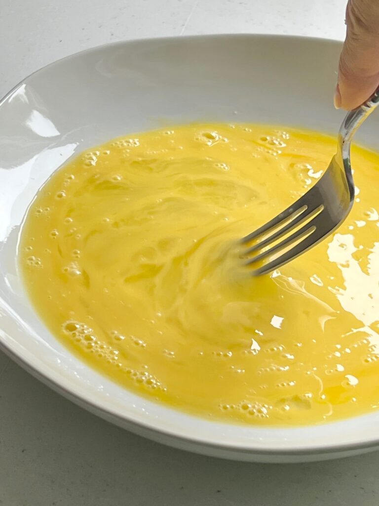 Stirring eggs with a fork.