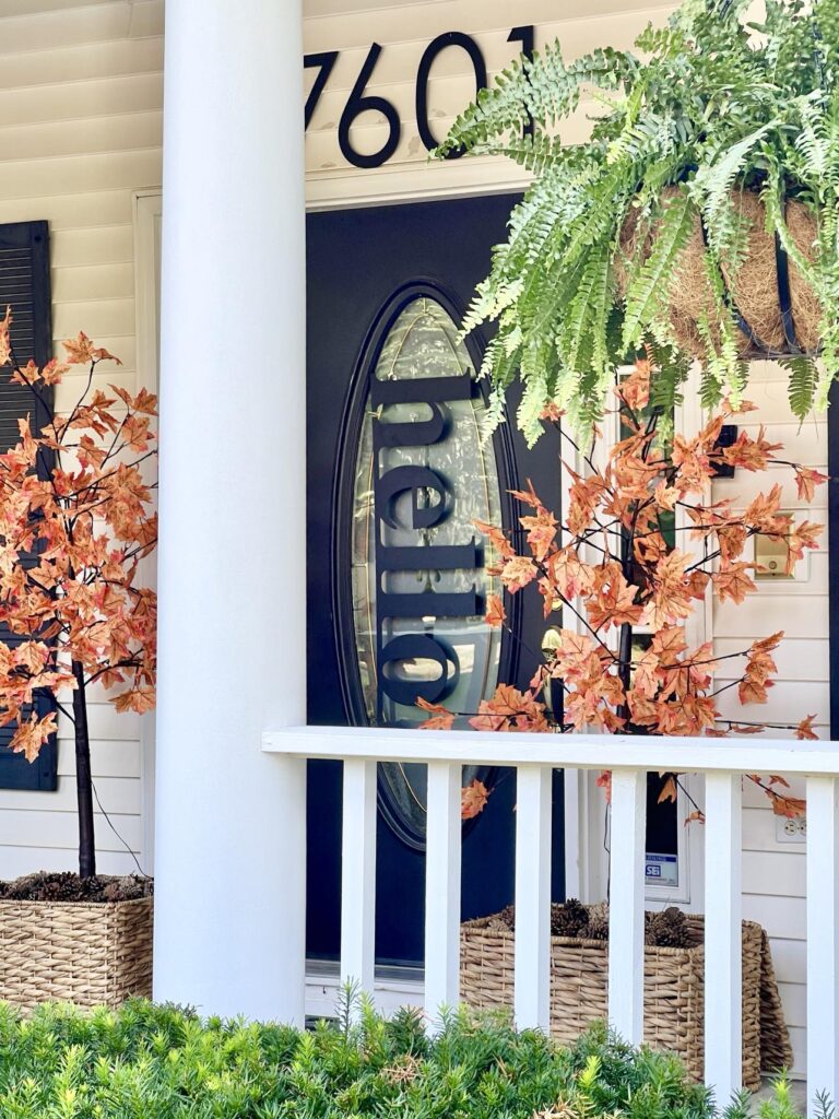 A front porch decorated for fall.