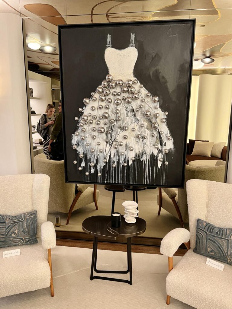artwork featuring a party dress with 3D silver baubles attached to the skirt.