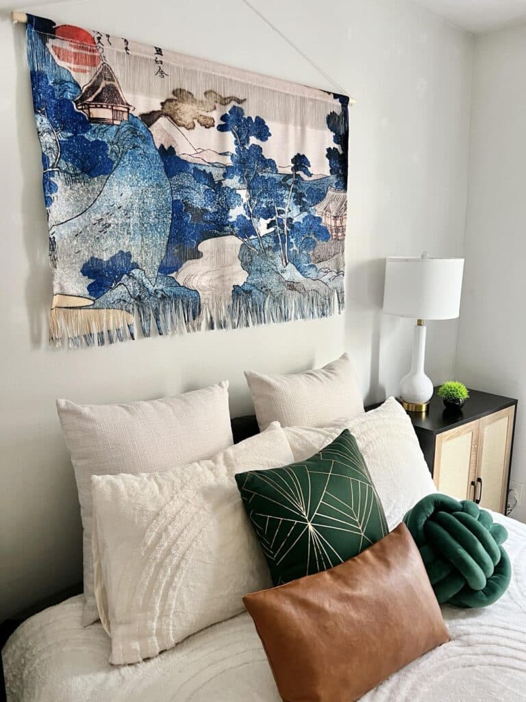 Green and brown throw pillows on a bed.