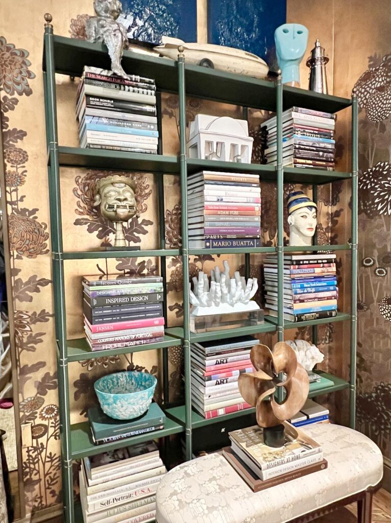 A bookcase styled with design books and home accents from around the world.