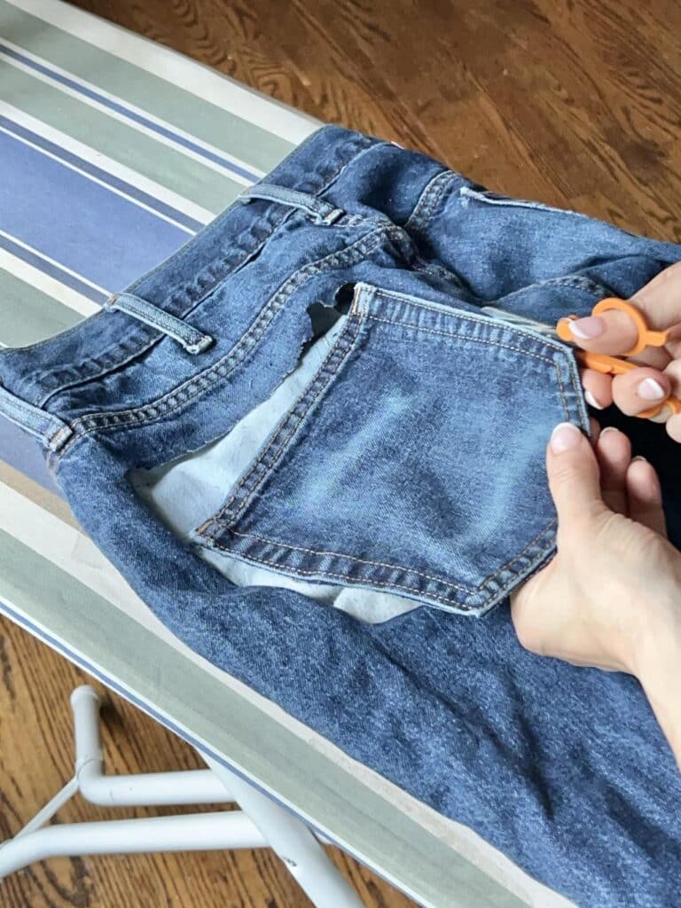 Cutting out the pocket from a pair of old jeans.