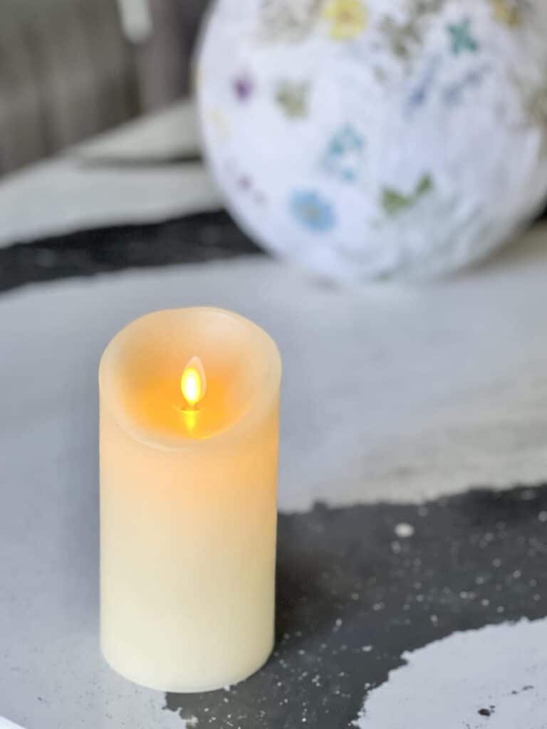 A faux candle with a flickering flame.