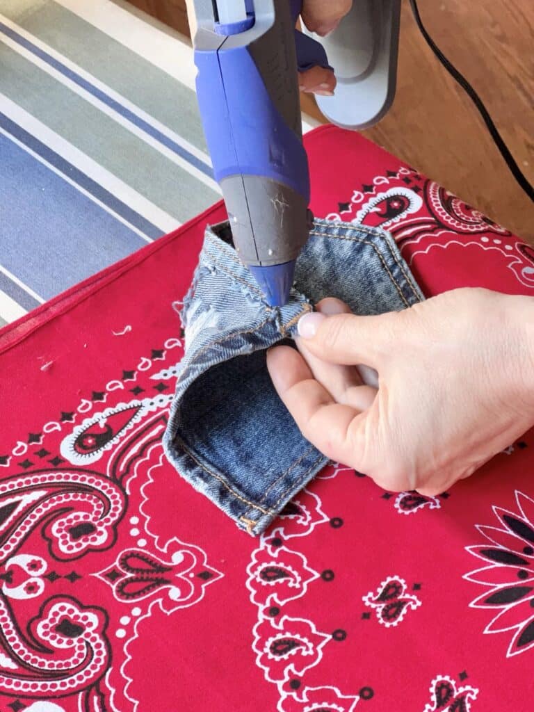 Hot gluing a denim pocket to one side of the reversible placemat.