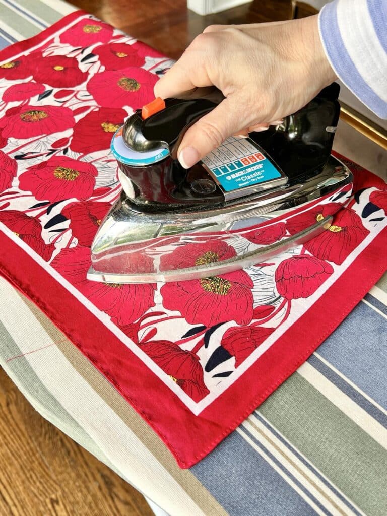 Ironing on the coordinating floral bandana to make a reversible placemat.