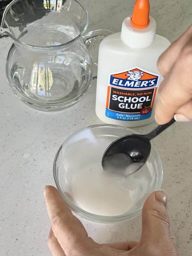 Stirring water in a bowl of Elmers glue.