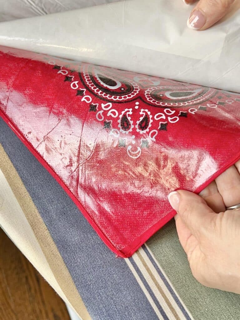 The shiny side of the bandana with the adhered Heat n Bond.