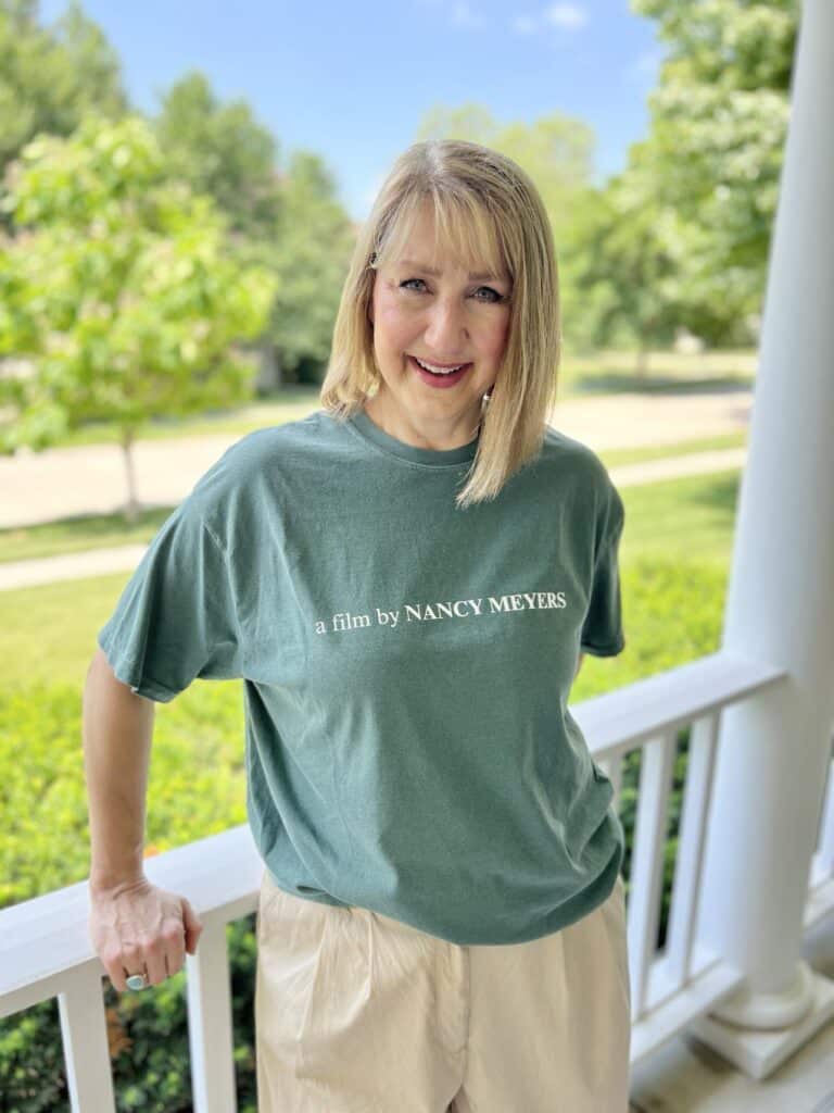 Woman wearing a t-shirt from Etsy that says "a film by Nancy Meyers"