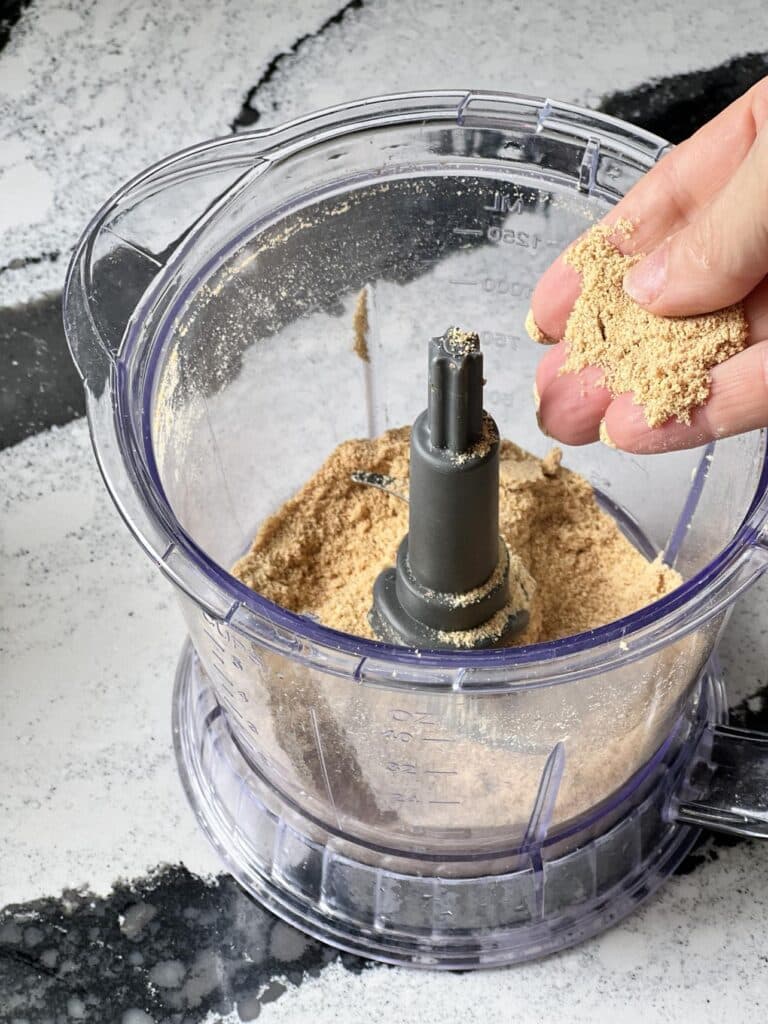 Crushed graham crackers in a food processor.