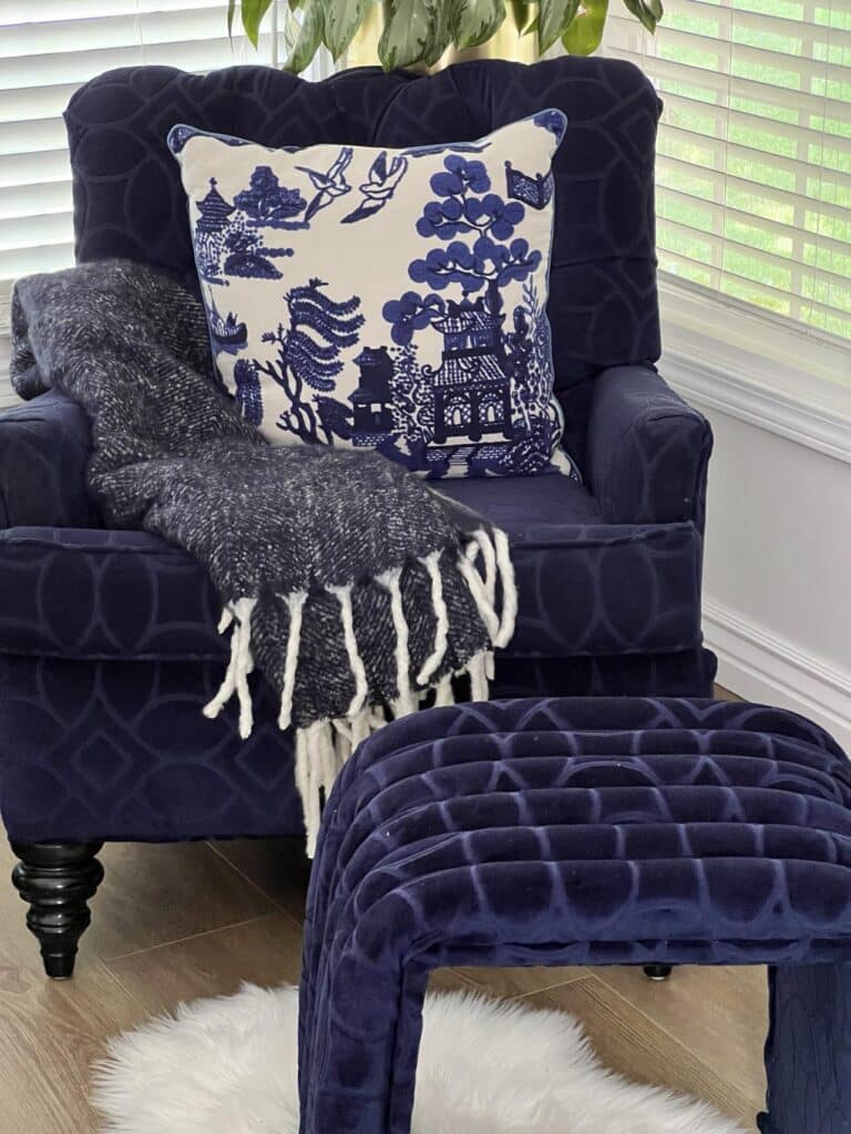A blue club chair with a coffee table ottoman diy upholstered in the same fabric.
