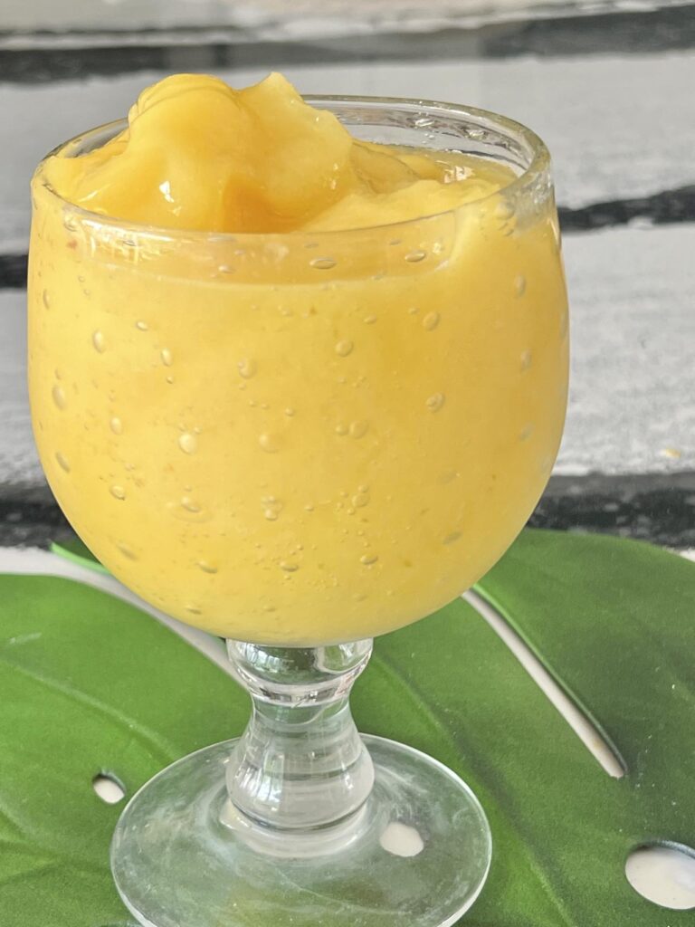 How to make mango a go go: A golden yellow smoothie drink in a glass goblet