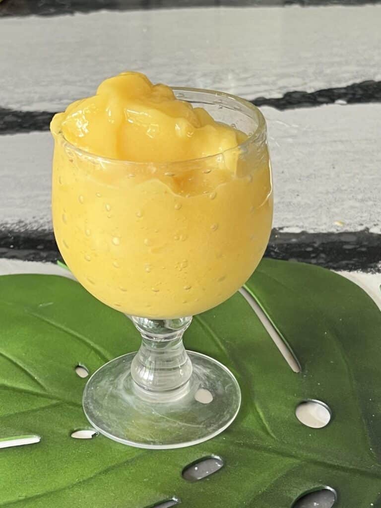 A mango a go go smoothie on a kitchen counter. Easy to learn how to make!