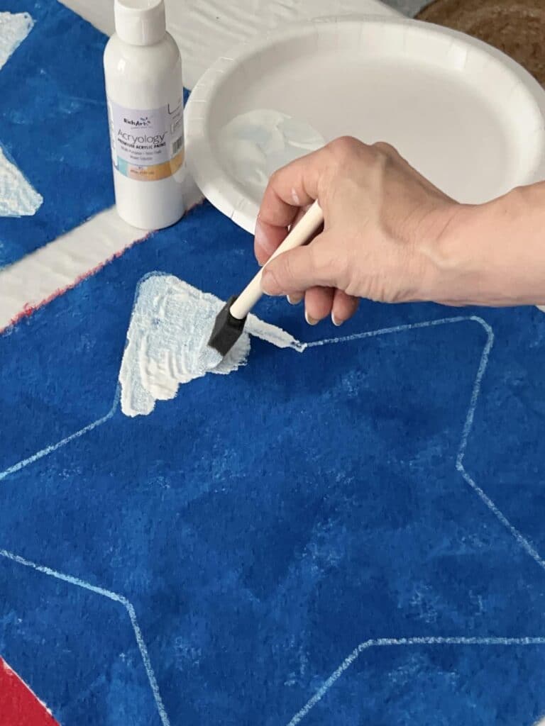 Painting the inside of the traced star with white paint.