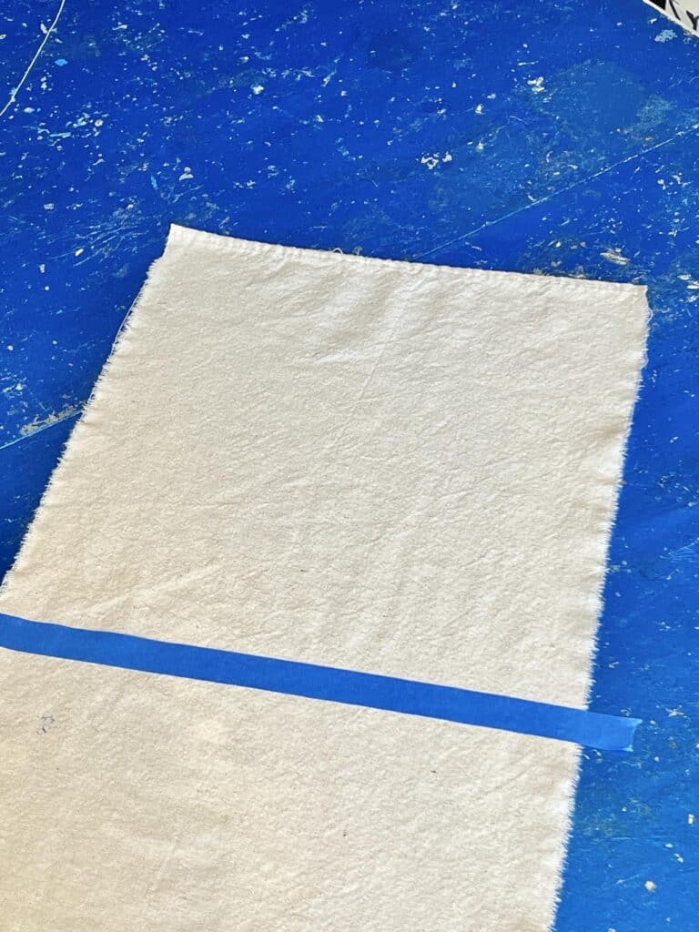 A perfect square marked by painters tape at the top of the DIY Flag Banner