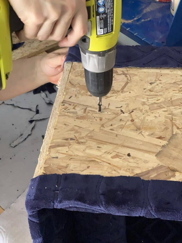 Drilling screws to secure a wood brace.