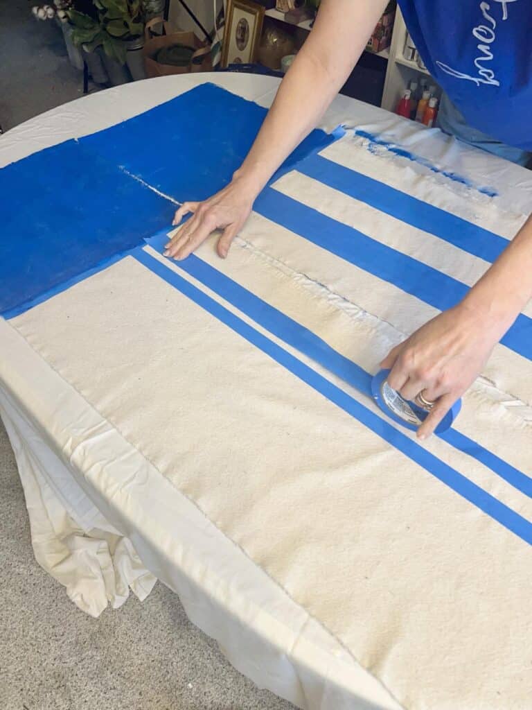 Taping off stripes to be painted on the DIY Flag Banner.