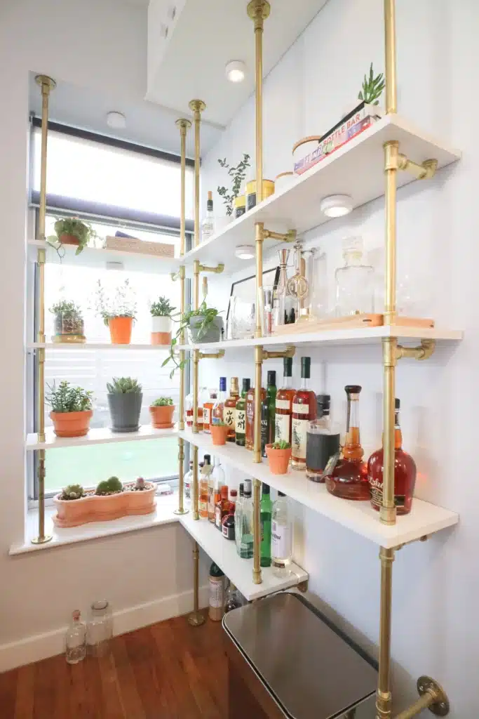 Brass bistro shelves hanging in a home.