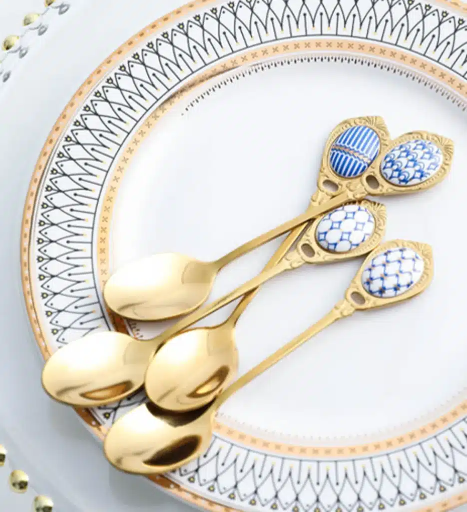 gold coffee spoons with blue and white porcelain handles.