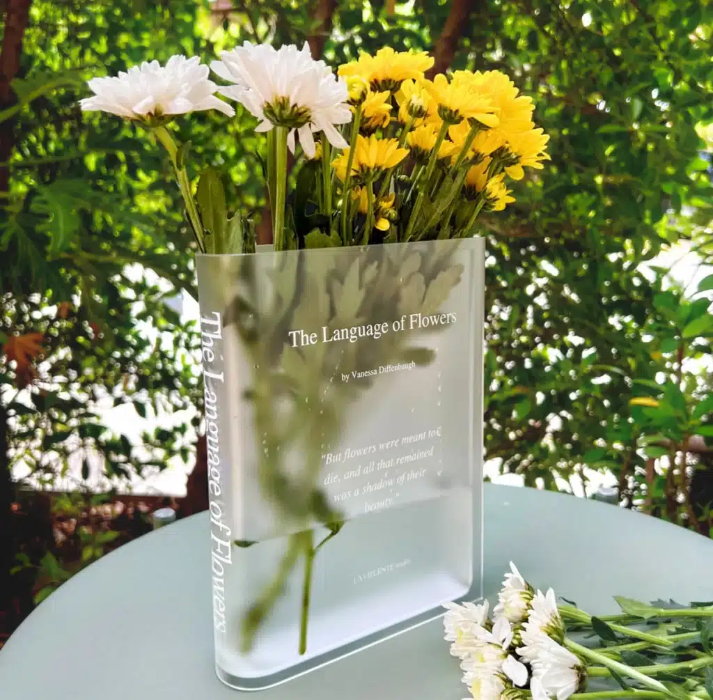 home finds: A glass vase in the shape of a book with the title "The Language of Flowers"