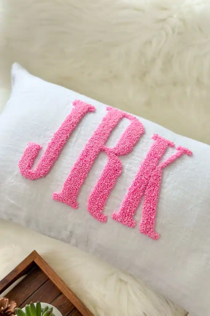 A pillow with the initials "JRK" monogrammed on it.