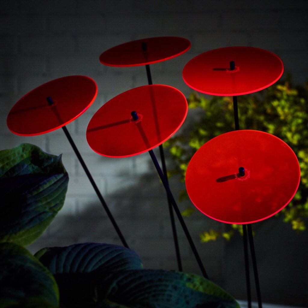 Red garden stakes that you can find in the backyard of aa home.