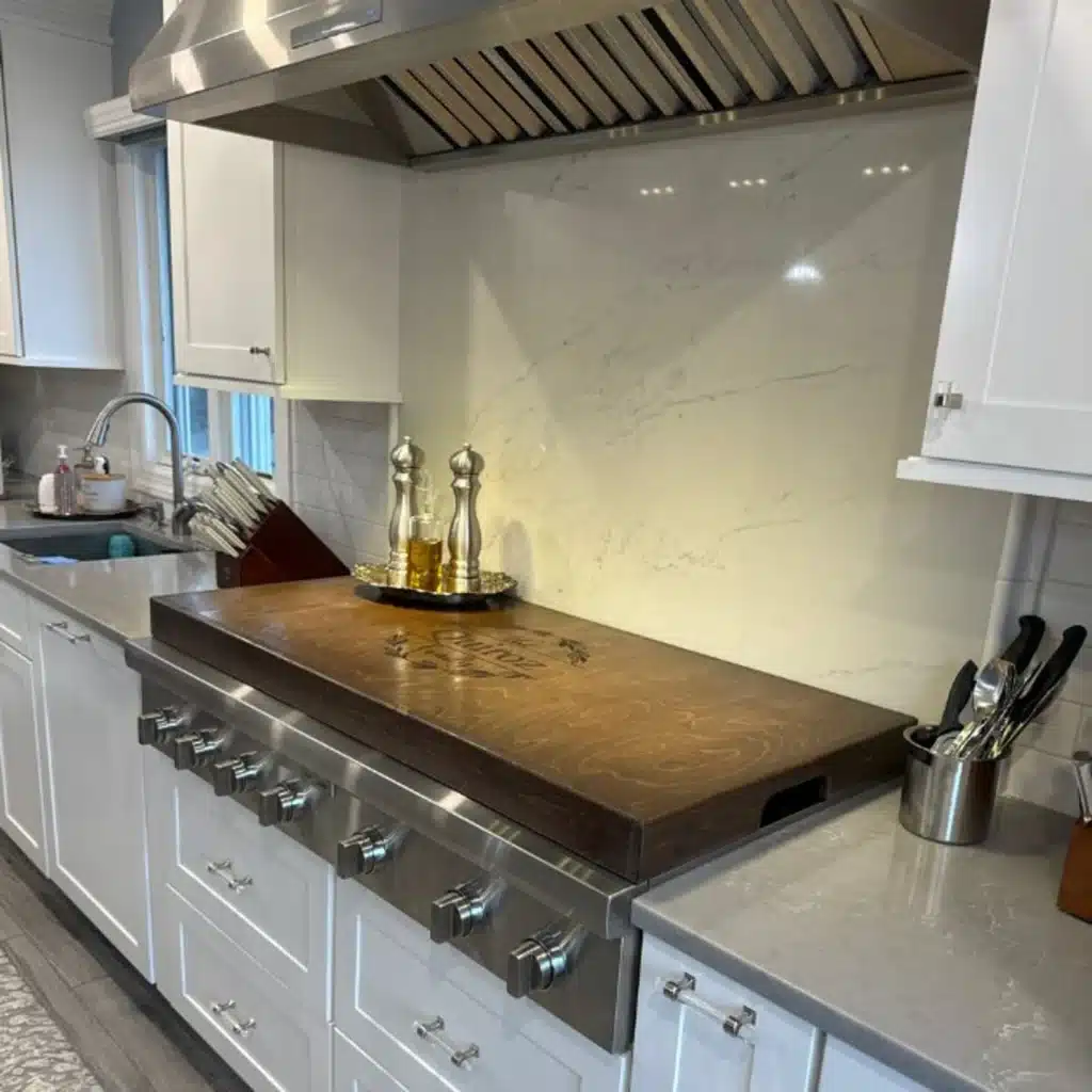 A custom stovetop cover with a personalized name on top.