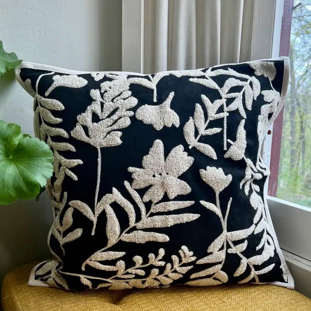 A black and white embroidered pillow found at home.