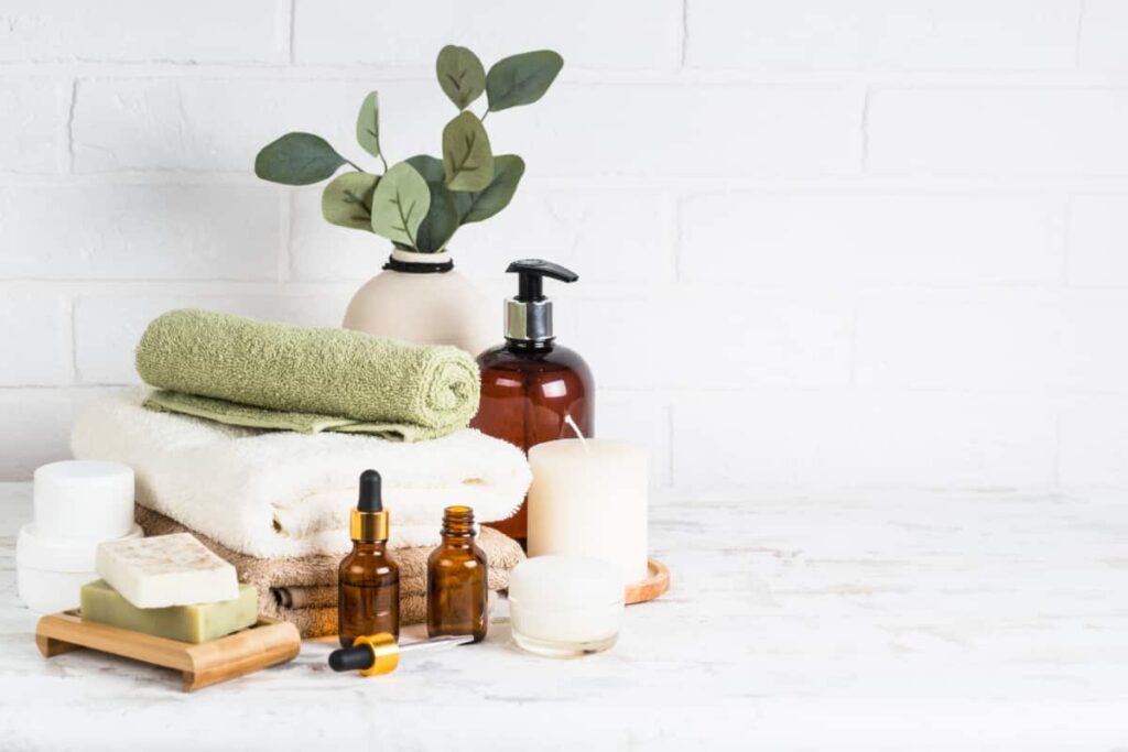 Rolled towels, soaps, and beauty bottles are bathroom countertop decor ideas.