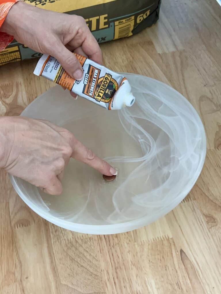 Gluing a penny over the hole of a glass light fixture cover.