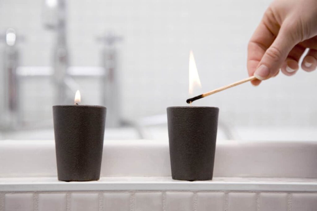 Lighting a candle in the bathroom.