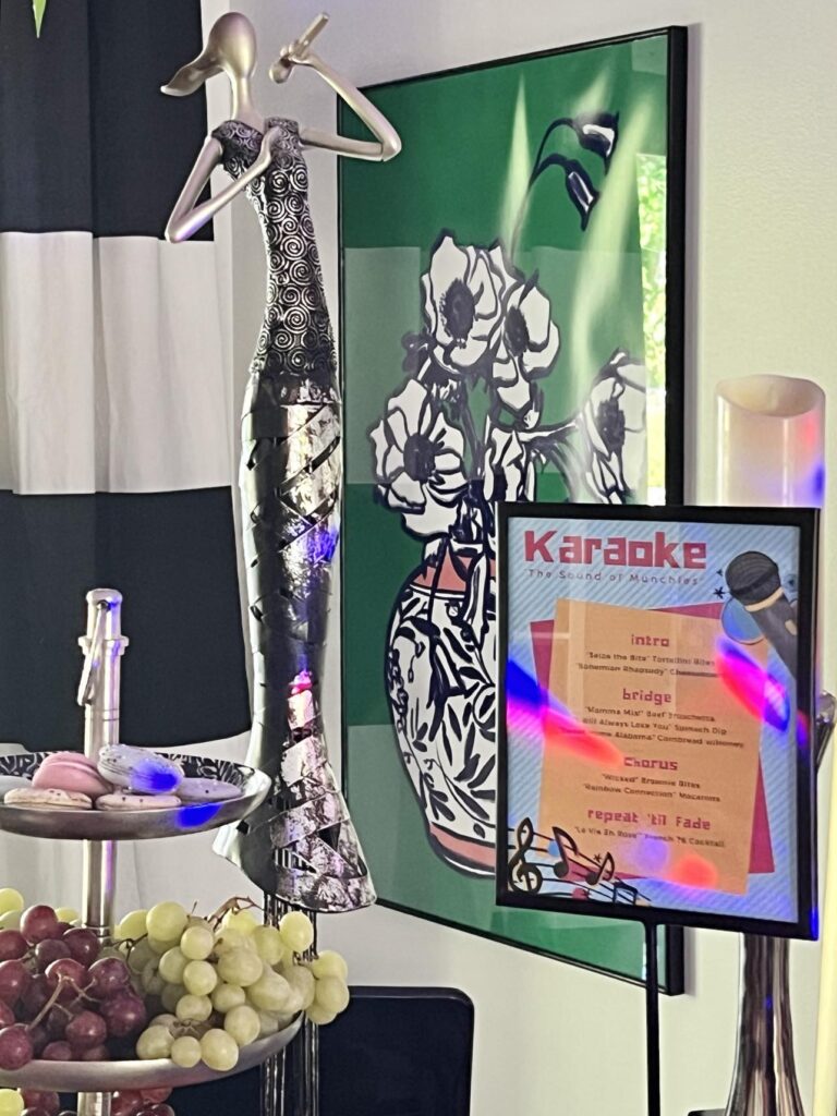 A sculpture of a singer with a microphone serves as the centerpiece for the karaoke party tablescape.