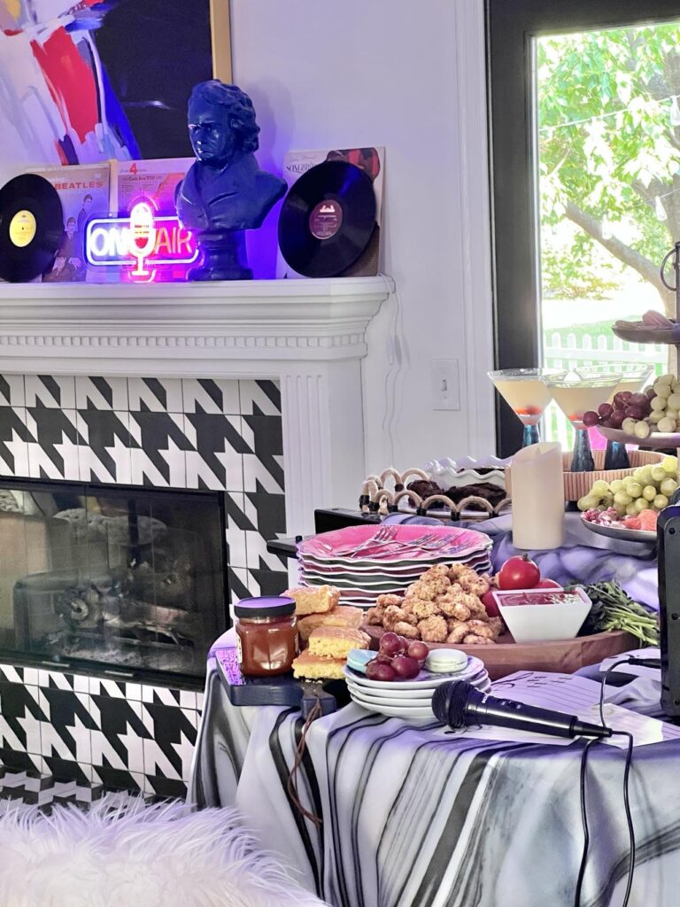 Karaoke table setting and stage area by fireplace.