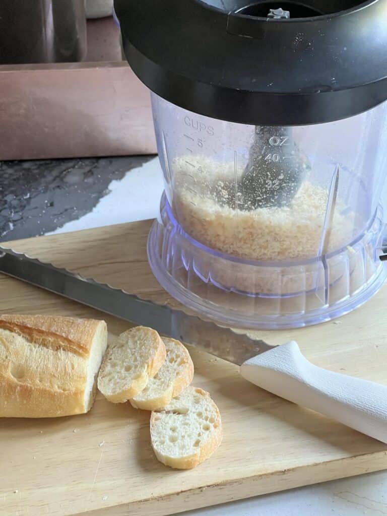 A food processor filled with bread crumbs.