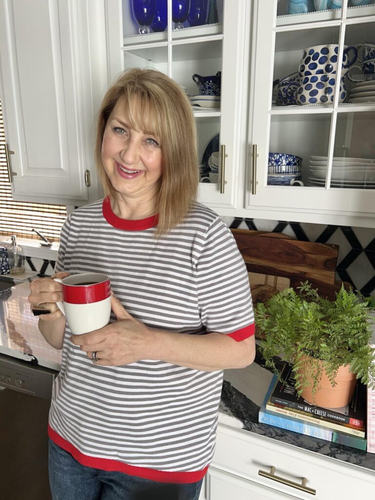 Woman holding a cup of coffee.