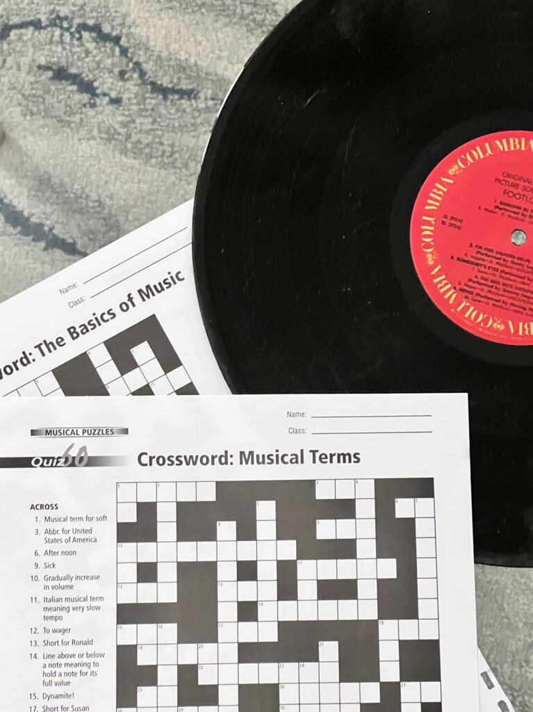 Music crossword games on top of a black record album.