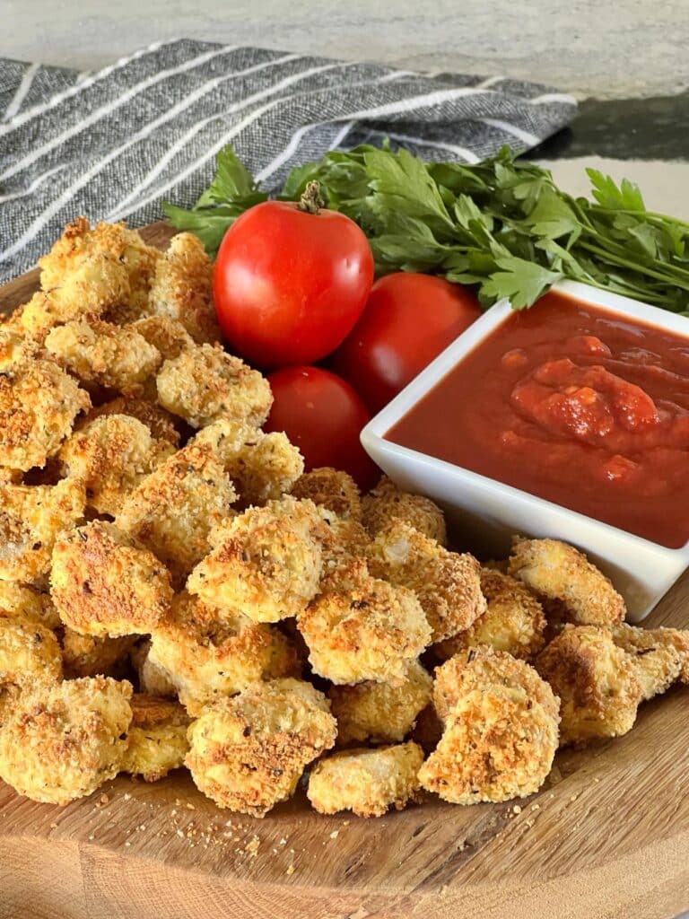 Tortellini bites on a serving platter with marinara sauce.