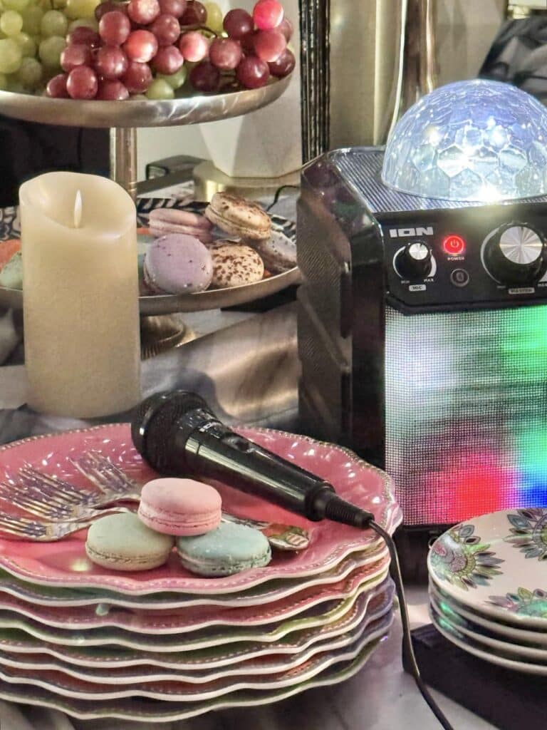 A stack of plates beside a karoke machine.