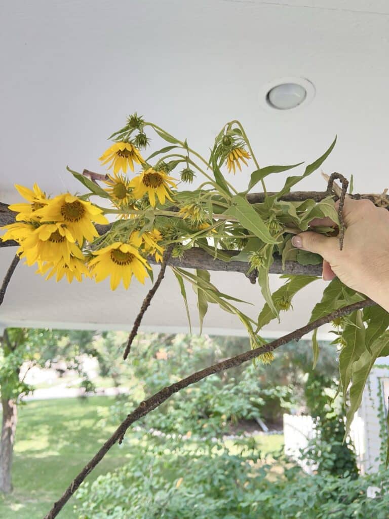 Adding flowers to the tree branch chandelier idea.