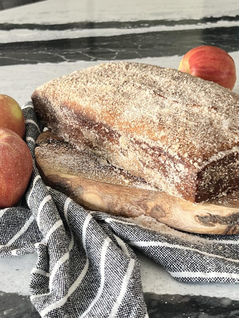 Apple cider donut bread on a bread board.