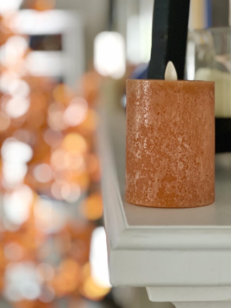 A russet colored pillar candle.